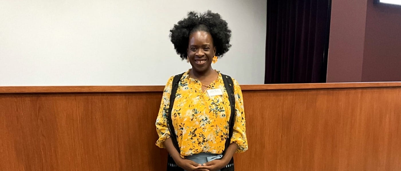 Bridget Kiah posing in front of an auditorium screen
