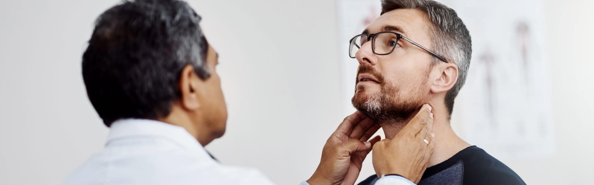 ENT physician examining patient's neck
