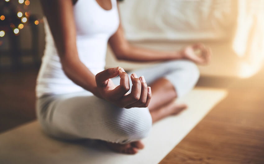 Woman meditating on yoga mat
