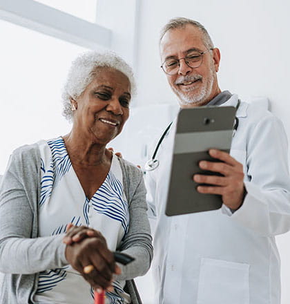 Patient with doctor looking at tablet