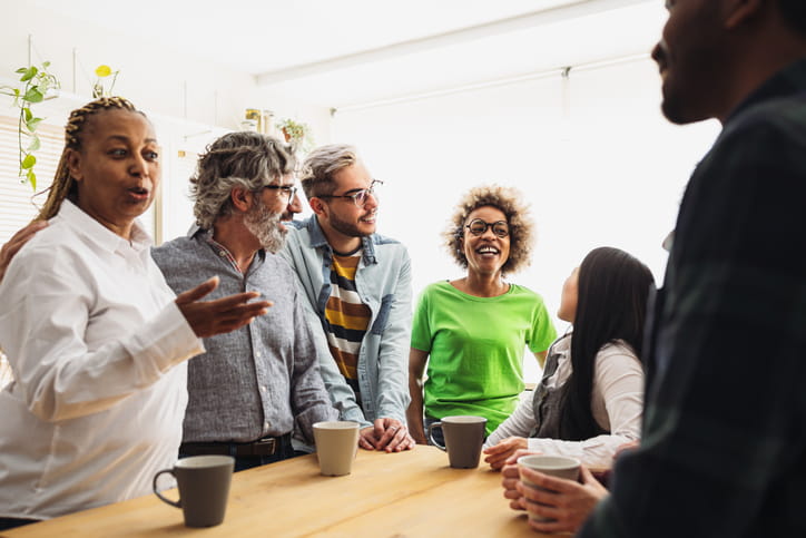 Group of people having a discussion with coffee
